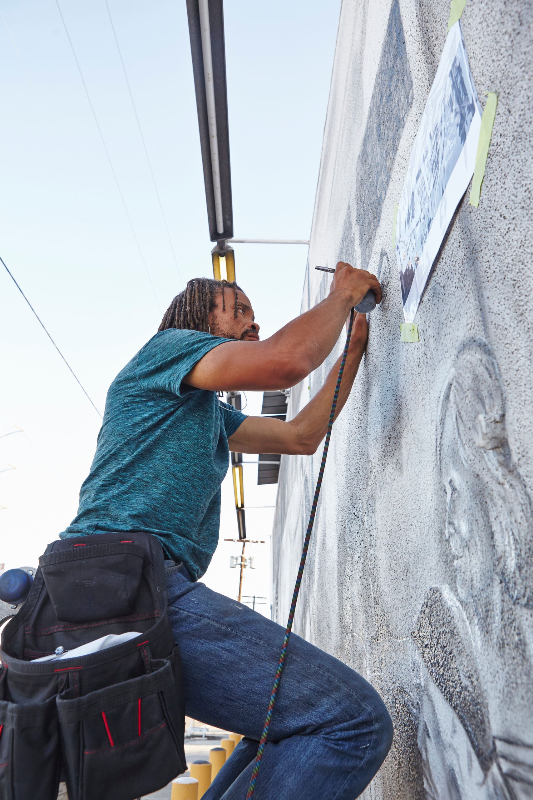 Male african american airbrush artist painting wall mural